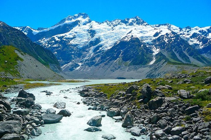 A breathtaking view of Aoraki/Mount Cook and the Tasman Glacier accented by clear waters and rugged landscapes invites exploration of New Zealand's stunning natural beauty. Perfect for unforgettable day trips.